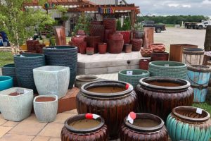 Large brown, grey, and green ceramic pots and garden accessories to plant flowers in for your backyard in Auburn, IL.
