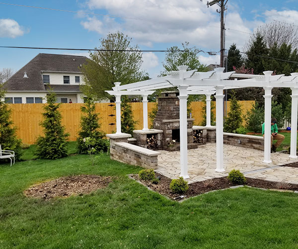 pergola, fireplace, and paver patio installed in backyard of springfield illinois home